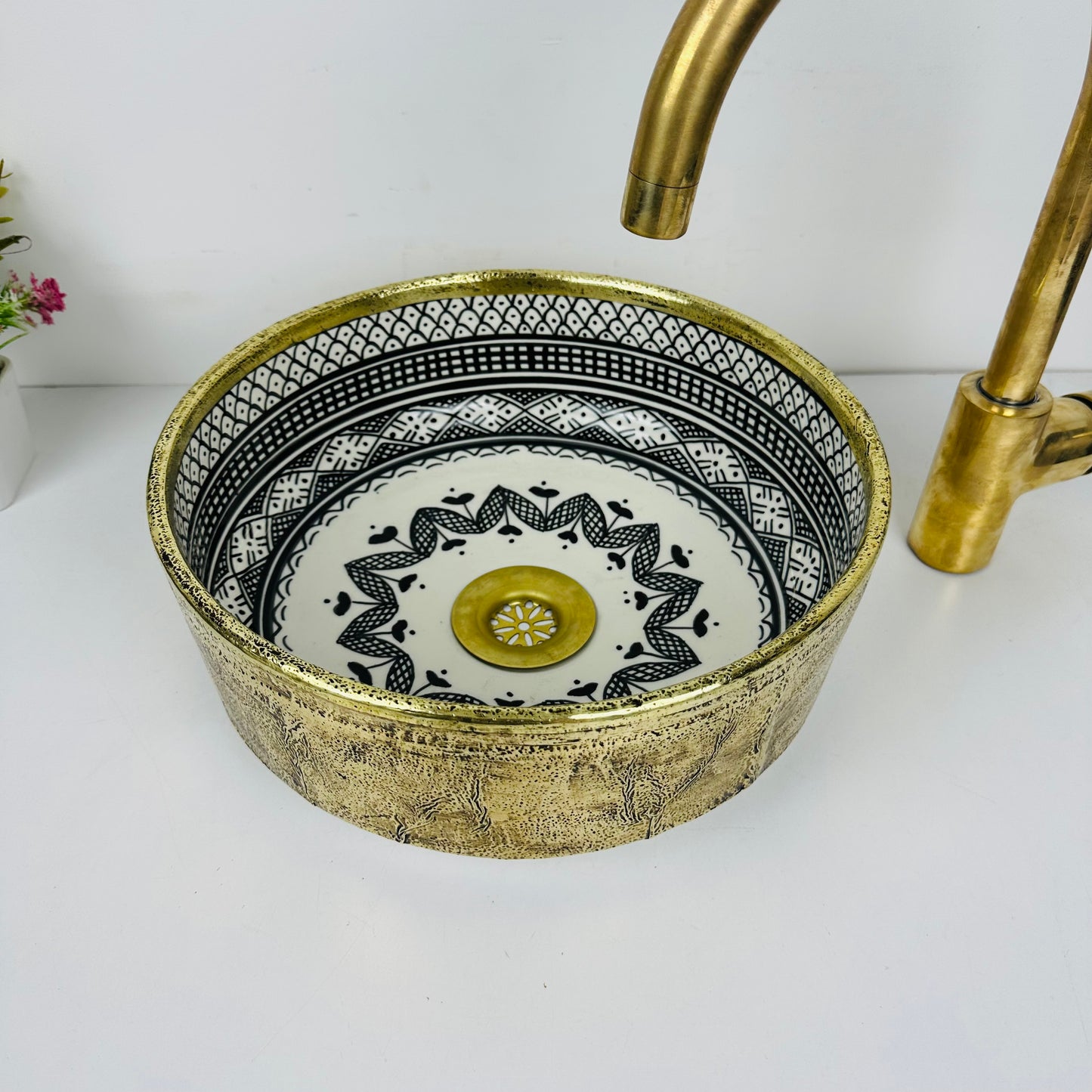 Luxury in Every Detail: Black and white Ceramic Sink with Goldish brass Embellishments