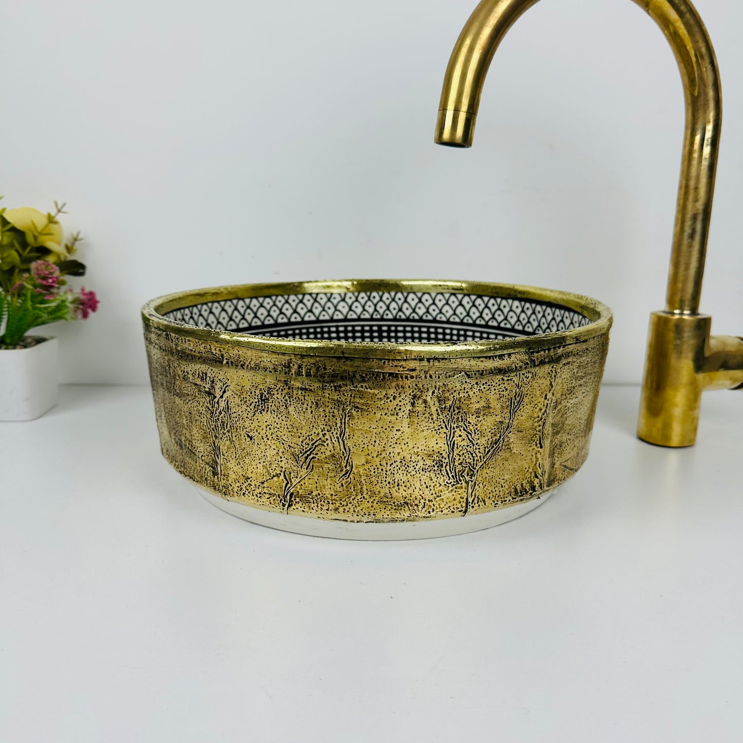 Luxury in Every Detail: Black and white Ceramic Sink with Goldish brass Embellishments