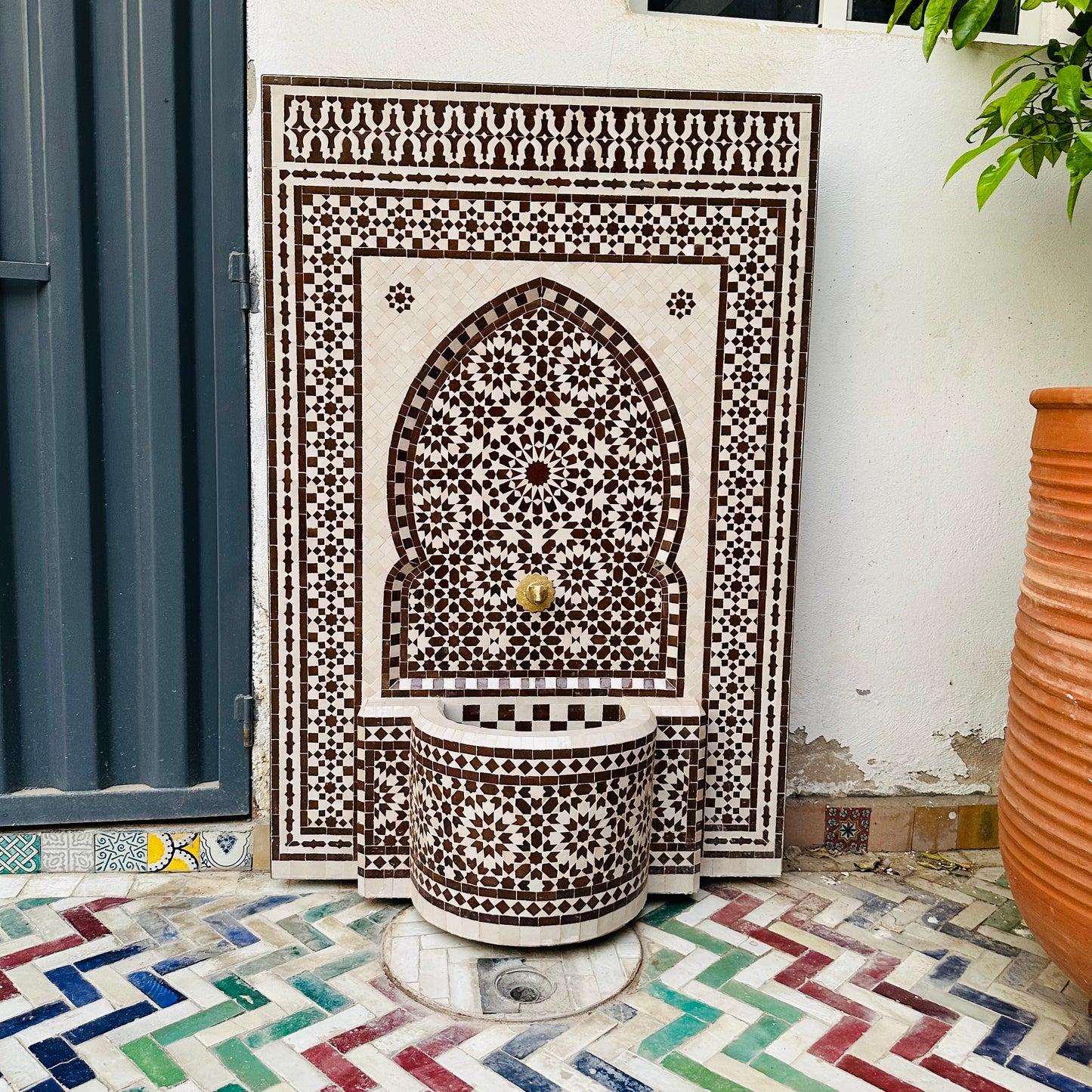 elegant Moroccan Zellige fountain in earthy brown and cream tones