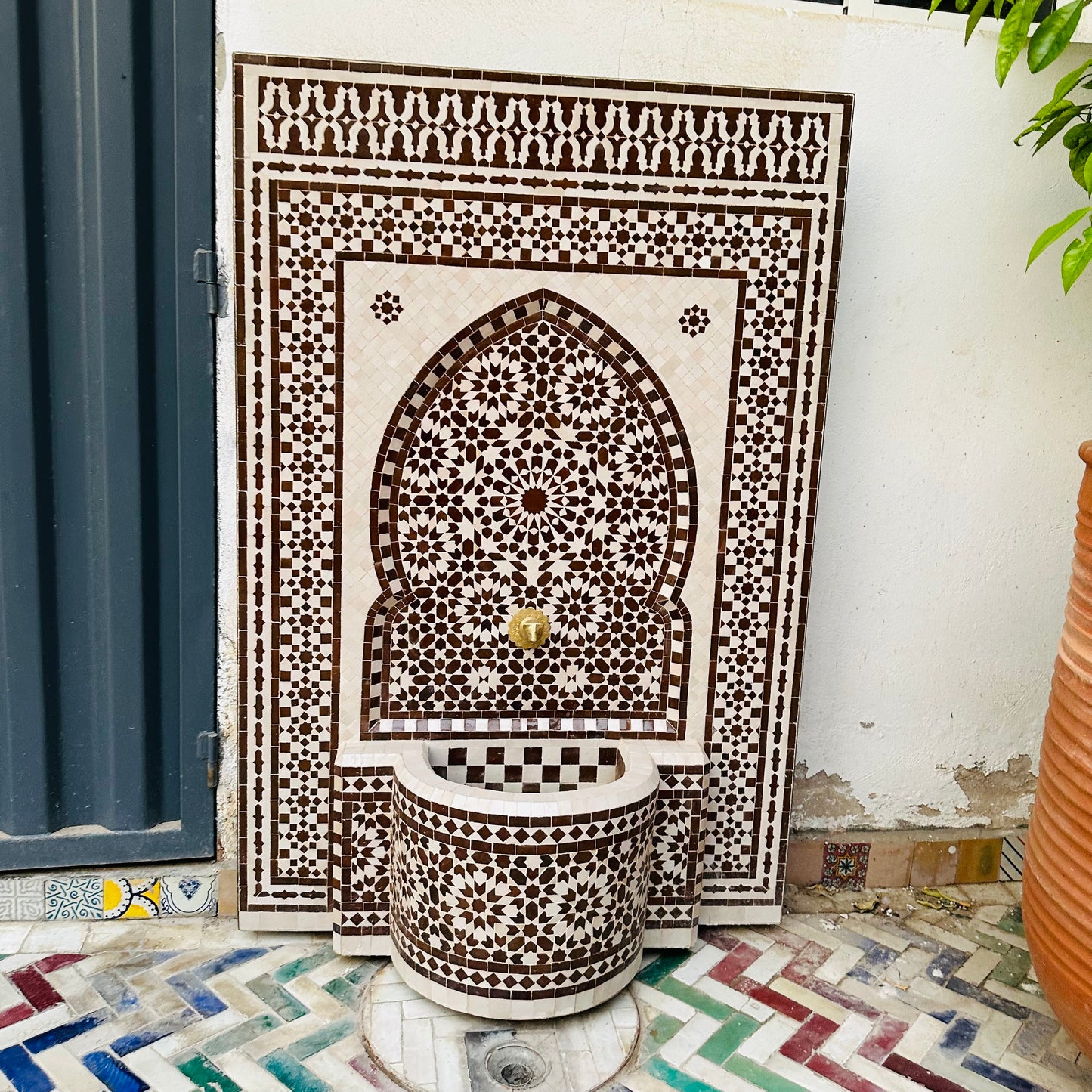 elegant Moroccan Zellige fountain in earthy brown and cream tones