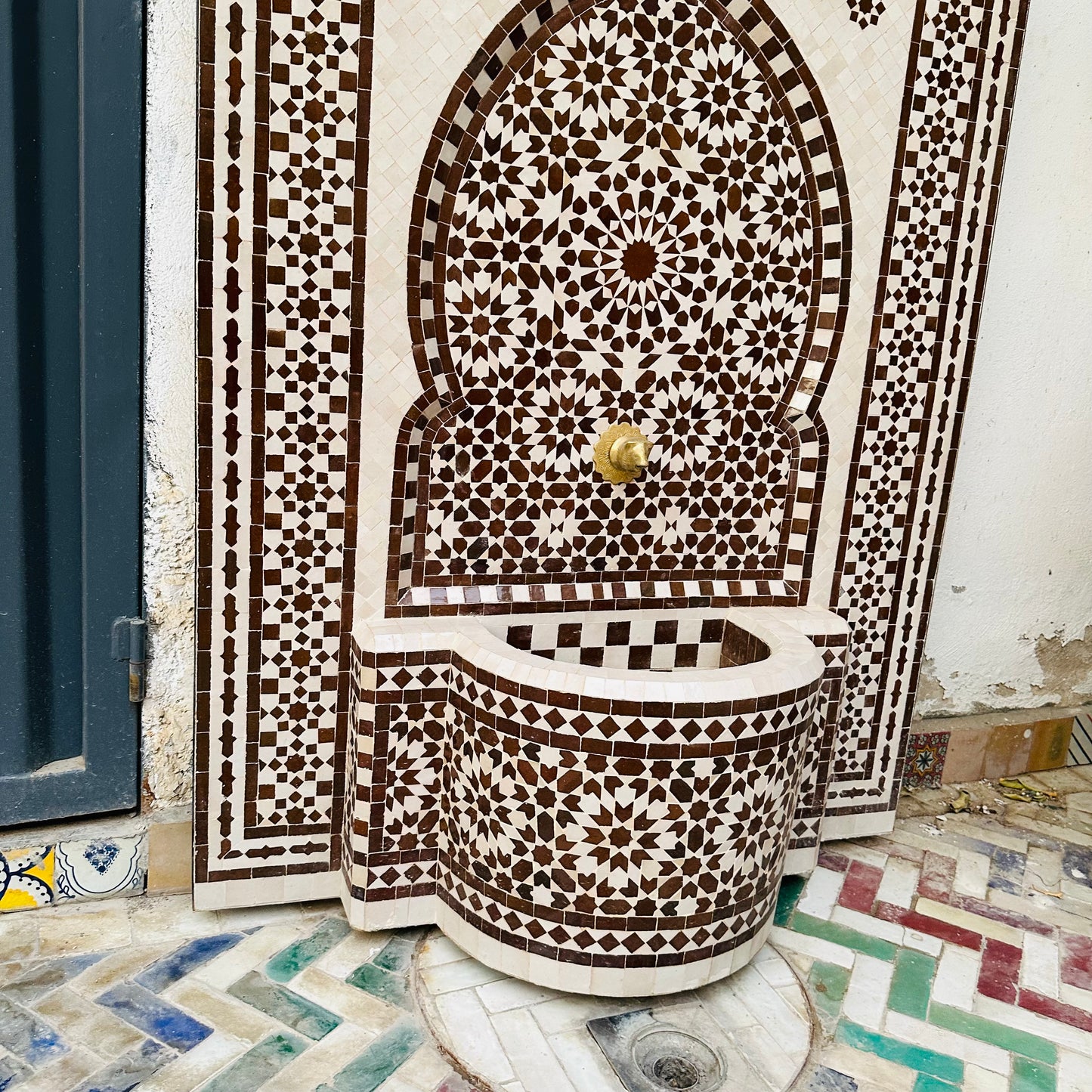 elegant Moroccan Zellige fountain in earthy brown and cream tones