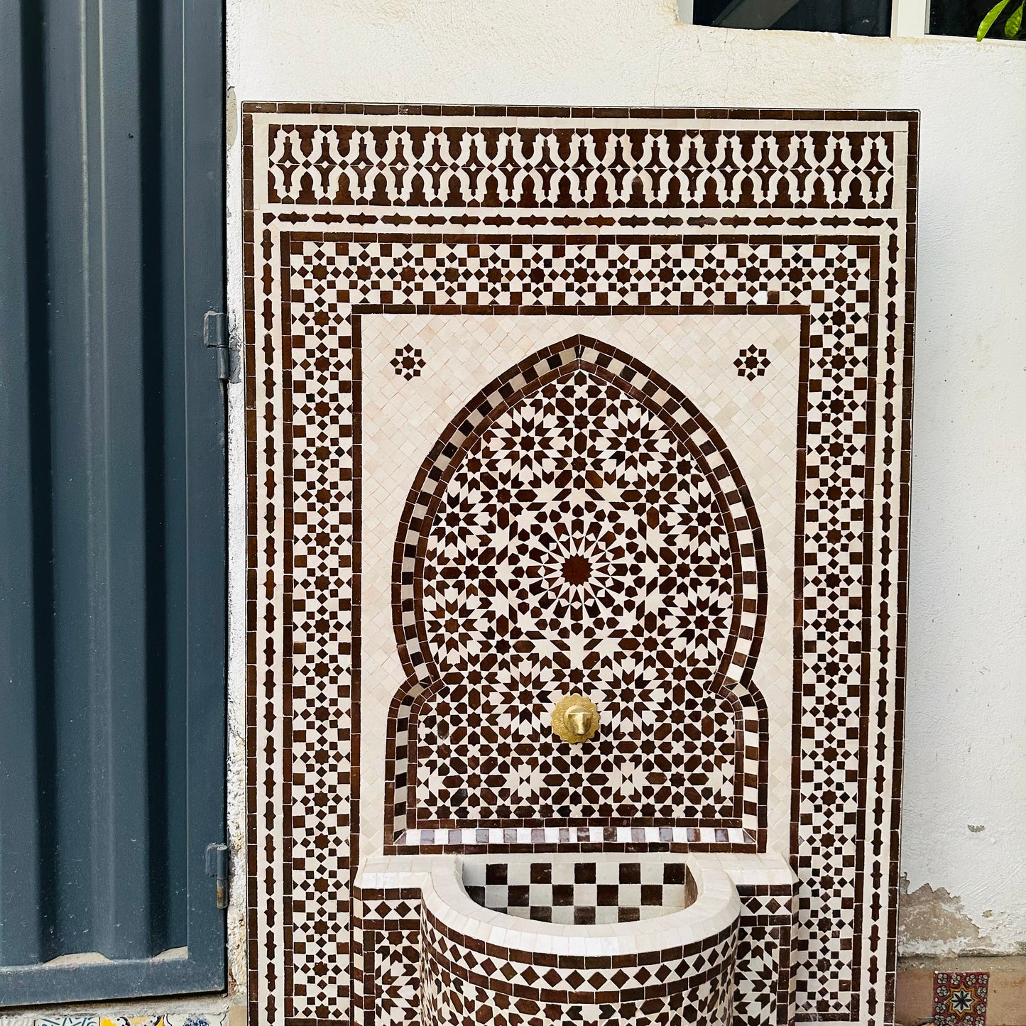 elegant Moroccan Zellige fountain in earthy brown and cream tones