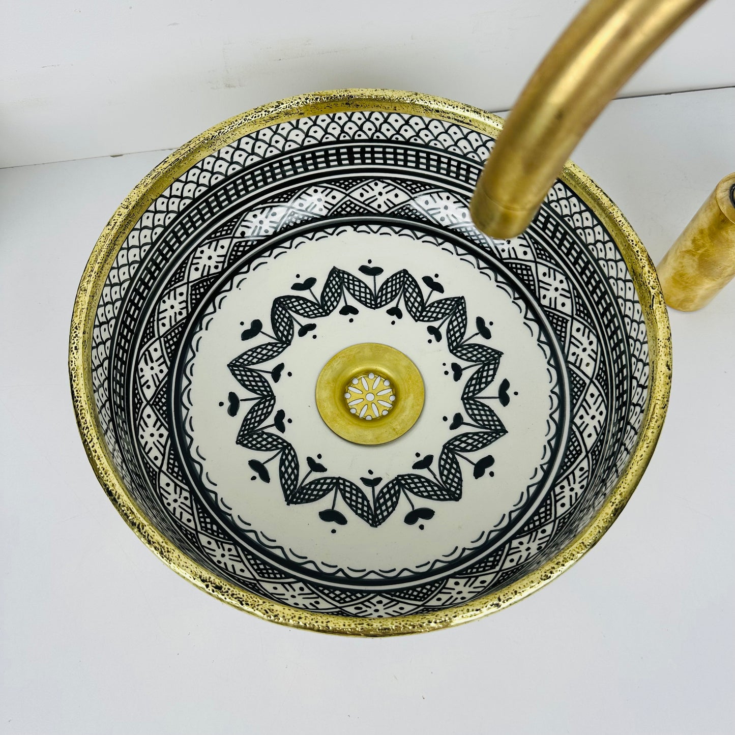 Luxury in Every Detail: Black and white Ceramic Sink with Goldish brass Embellishments