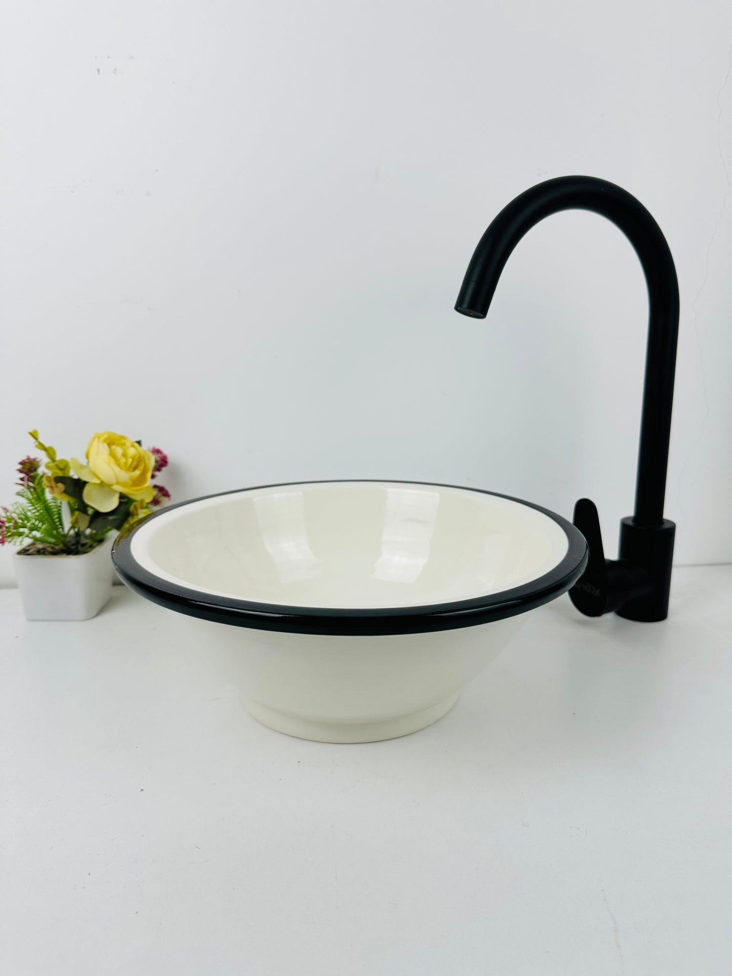 Classic Contrast: Handcrafted Ceramic Sink in Timeless Black and White Design