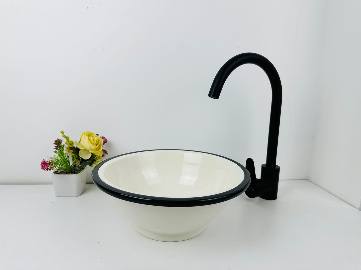 Classic Contrast: Handcrafted Ceramic Sink in Timeless Black and White Design